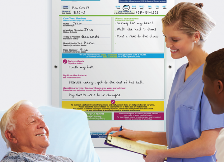 behavioral health patient & nurse in patient room with safety whiteboard