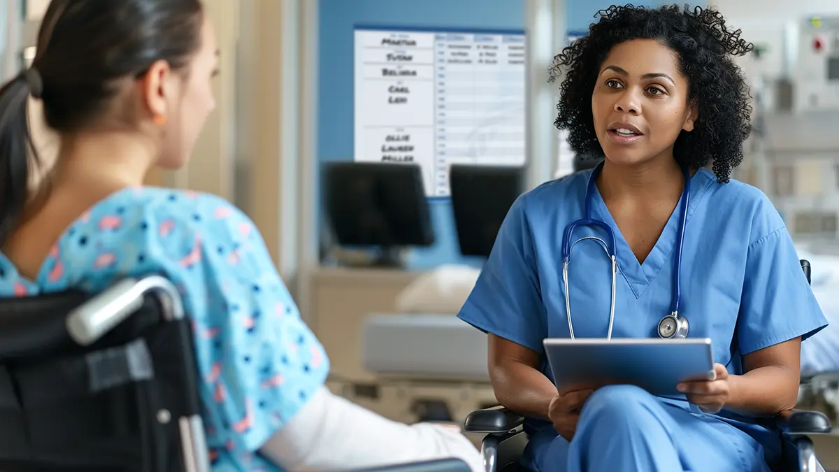 Nurse and Patient discuss care in high end hospital room with window out into the nurse unit with custom board in the hospital hall