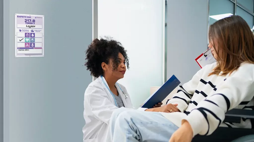 doctor and patient talk in hospital hall with custom safety door entry boards
