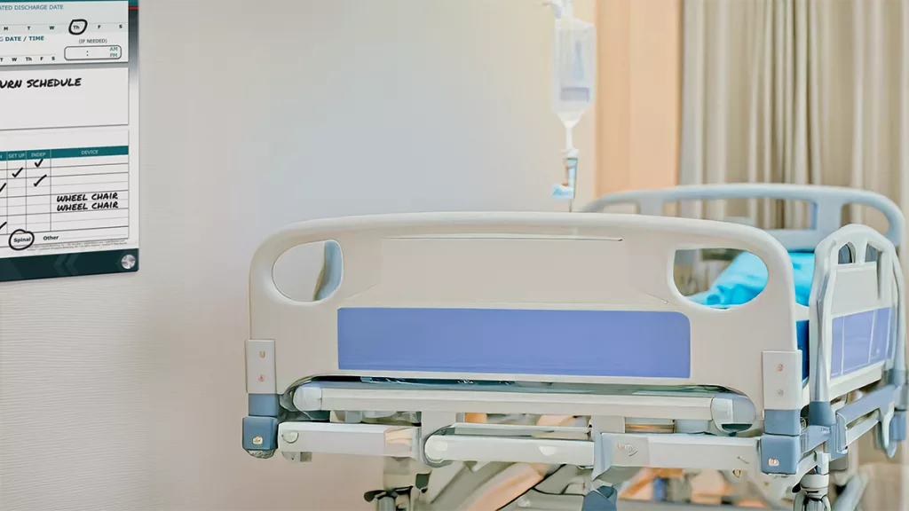 Patient bed in room with custom patient board