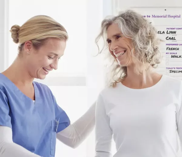 Nurse and patient in Behavioral Health hospital room with custom VisiCare Safety Boards