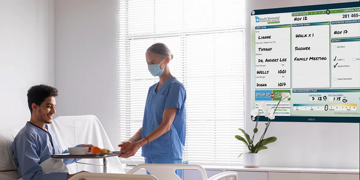 nurse and patient in patient room with custom quick change patient board in VisiCare Plexi Board interchangeable board style