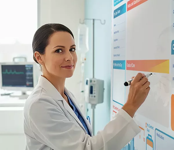 Nurse Practitioner adds notes to custom patient beside communication board