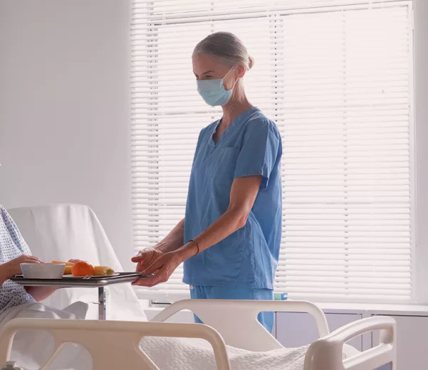 Nurse and patient talk in environment of care with custom patient glass whiteboard
