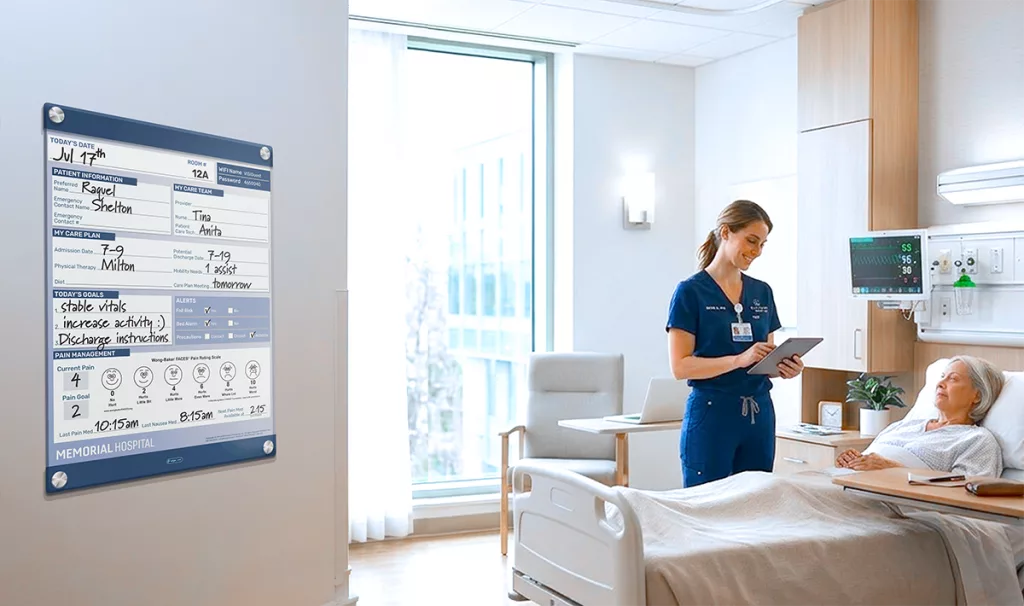 nurse and patient in modern hospital room with custom glass patient board