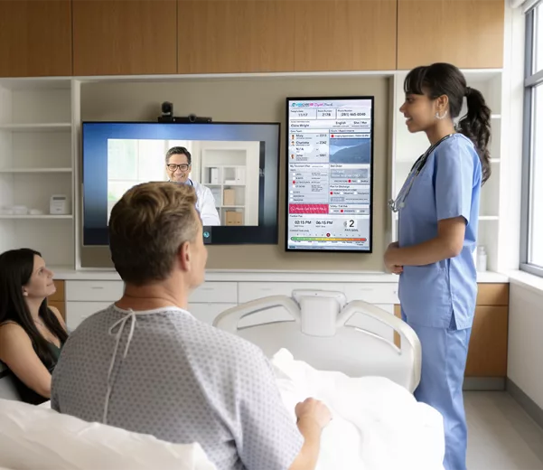 Patient in Telehealth discussion with doctor and nurse in modern hospital room with custom electronic patient board
