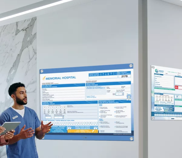 Nurse browses showroom of custom patient boards in whiteboards, glass boards and digital boards