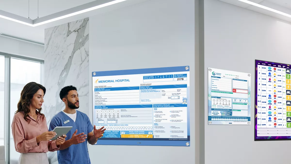 Nurse browses showroom of custom patient boards in whiteboards, glass boards and digital boards