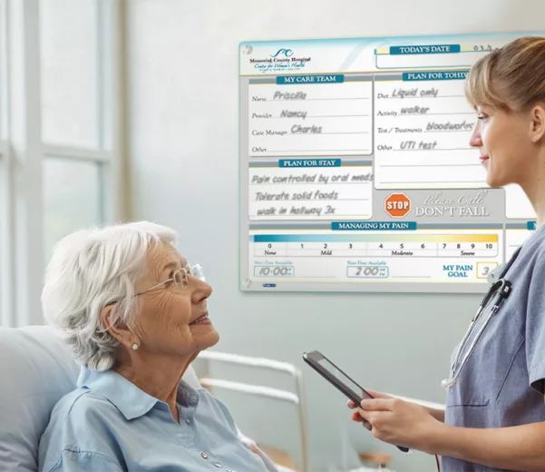 nurse and patient discuss care in excellent care hospital with custom patient board in VisiCare Glass Board Hybrid profile board style
